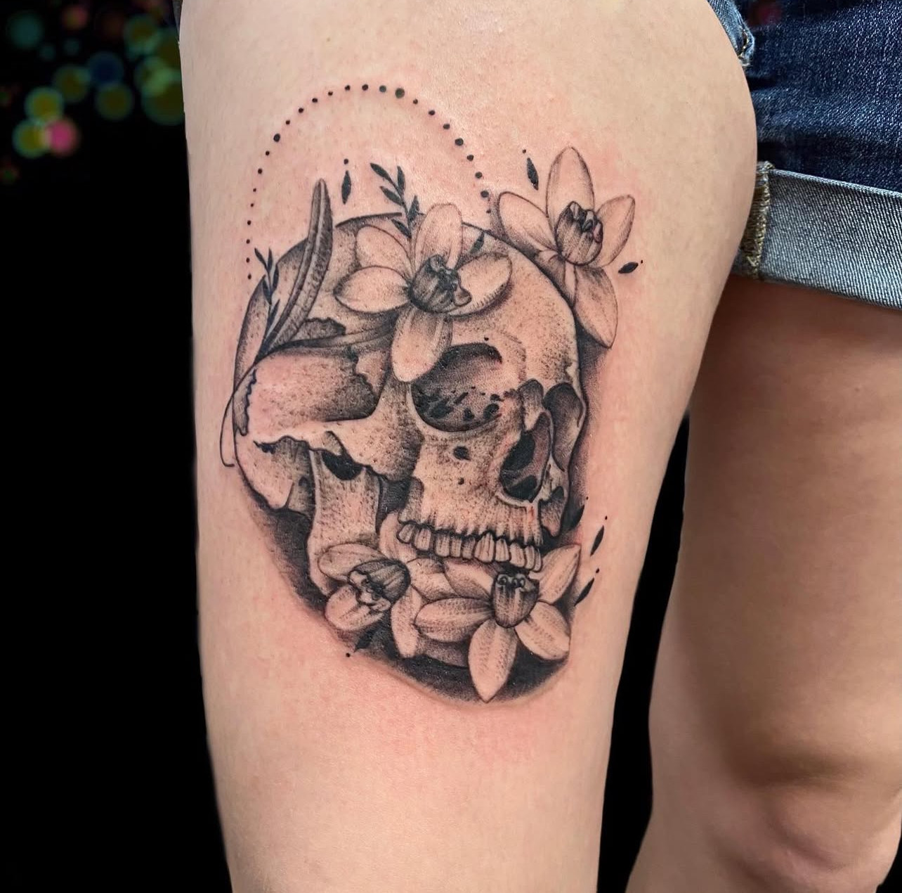 Black and gray skull with flowers fine line tattoo